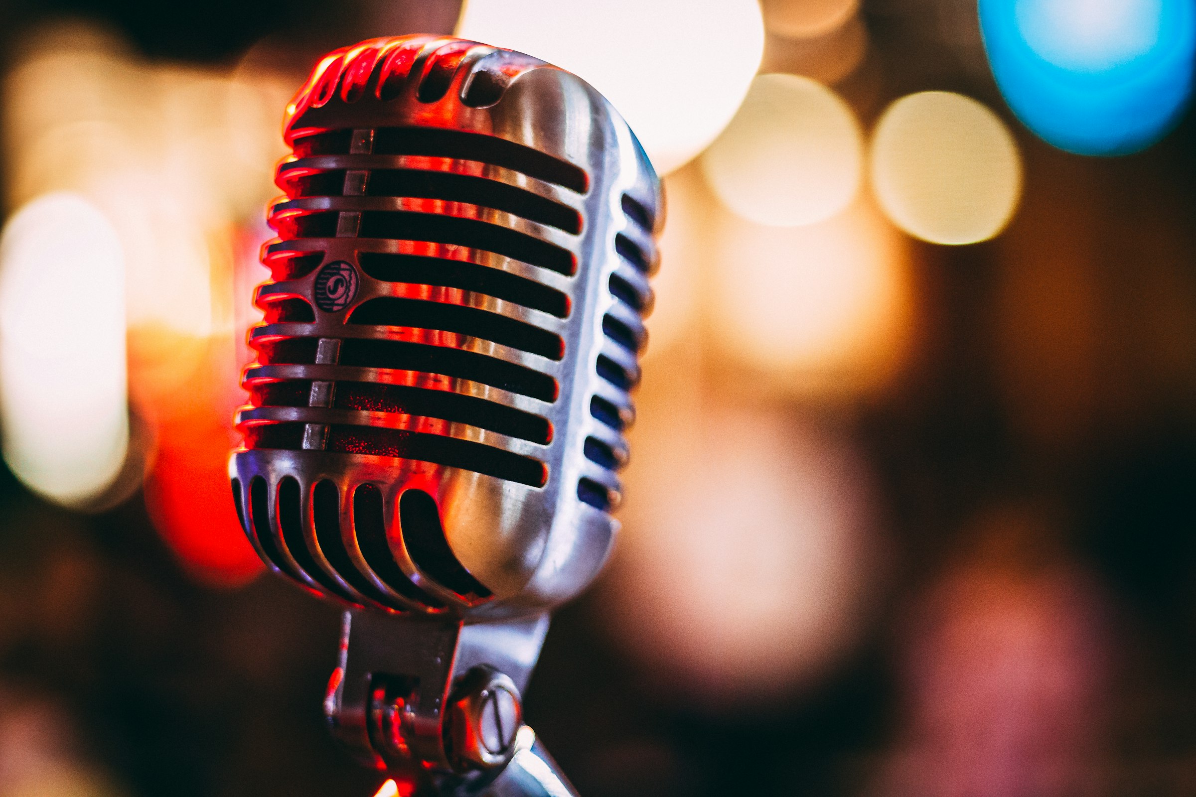 A vintage microphone lit with warm bokeh light